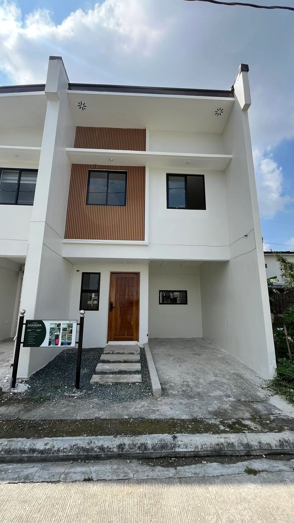 Finished townhome facade with wood-slat accent